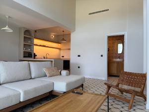a living room with a couch and a table at Kırmızı Bağ Resort in Kuscular