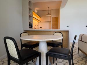 a table and chairs in a room with a kitchen at Kırmızı Bağ Resort in Kuscular +2 photos