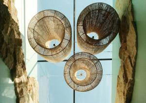 a group of wooden baskets hanging on a wall at Luuna de Jade in Oaxaca City