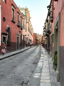 an empty street in a city with buildings at Casa H in San Miguel de Allende