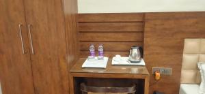a hotel room with a table with two bottles on it at Hotel New M I Plaza in Gaya