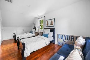 a living room with two beds and a couch at BlackBerry - Private home with Jacuzzi year-around in East Hampton +11 photos
