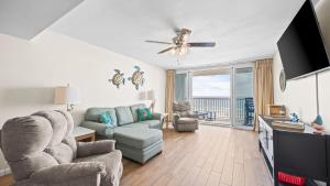 a living room with a couch and chairs and a tv at Romar Tower 5C in Romar Beach