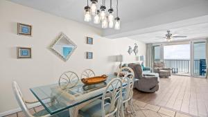 a dining room with a glass table and chairs at Romar Tower 5C in Romar Beach