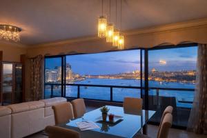 a living room with a view of the water at Breathtaking Valletta Harbour View - Exclusive in Sliema