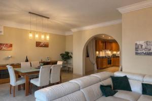 a living room with a white couch and a table at Breathtaking Valletta Harbour View - Exclusive in Sliema