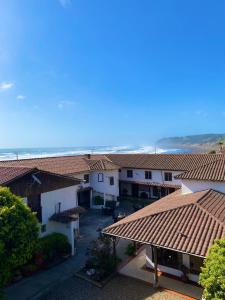 an overhead view of a group of buildings with roofs at Hosteria Iloca in Iloca