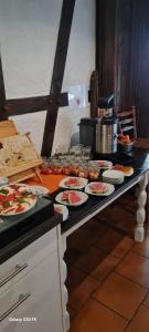 a table with plates of food on top at Landhotel zur guten Quelle in Eisenach