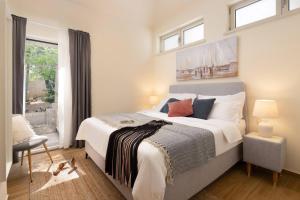 a bedroom with a large bed and a window at New Luxury Villa Korcula Timeless with private pool, Free Parking, Seafront, for 6 persons in Korčula +48 photos