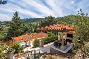 a house with a gazebo in a garden at New Luxury Villa Korcula Timeless with private pool, Free Parking, Seafront, for 6 persons in Korčula