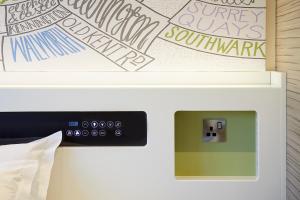 a microwave oven sitting next to a wall with graffiti at hub London - Marylebone in London +17 photos