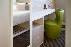 a room with a desk and a green chair at hub London - Marylebone in London