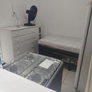 a kitchen with a stove and a bed in it at Albergue da Vila Mariana in São Paulo