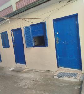 two blue doors and windows on a building at Albergue da Vila Mariana in São Paulo