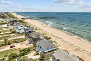 an aerial view of a beach with houses and the ocean at 7675 - Sweet Caroline in Avon