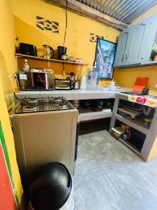 a kitchen with a stove and a counter top at Sunzal Bungalow Aloha in El Sunzal