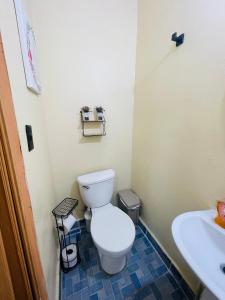 a bathroom with a toilet and a sink at Sunzal Bungalow Aloha in El Sunzal +11 photos