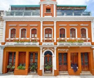 an orange building with plants on the windows at Masaya Santa Marta in Santa Marta