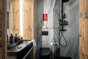 a bathroom with a sink and a shower at Kitz Alpine Apartments - City Center in Kitzbühel