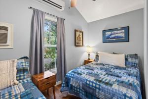 a bedroom with a bed and a window at Gil's Bayou Cabins in Ocean Springs