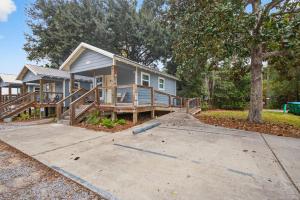 a home with a large porch and a house at Gil's Bayou Cabins in Ocean Springs