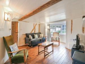 a living room with a couch and a table at The Old Smithy in Cambridge