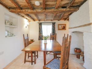 a dining room with a wooden table and chairs at The Old Smithy in Cambridge