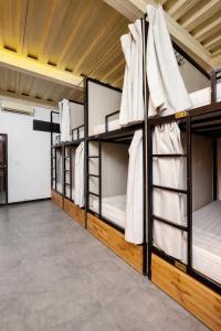 a row of bunk beds in a room at Brotherhood Loop Hostel Station in Làng Lap