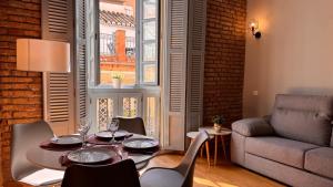 a living room with a table and chairs and a couch at Atlas in Málaga