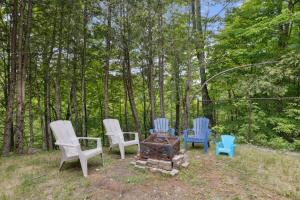 a group of chairs sitting around a fire pit at Modern Cottage Laurentians Private Pool & Nature in Brownsburg +43 photos