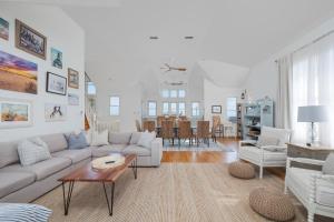 a living room with a white couch and a table at 5468 - Mermaids' Lagoon in Nags Head +44 photos