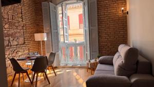 a living room with a couch and a brick wall at Atlas in Málaga +17 photos