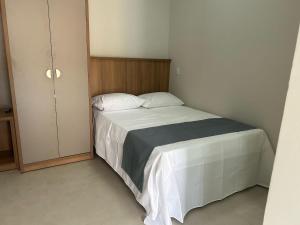 a small bedroom with a bed and a cabinet at Studio J&C 01 in Primavera do Leste