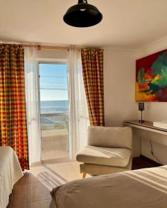a bedroom with a window with a view of the ocean at Hosteria Iloca in Iloca +41 photos