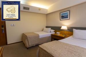 En eller flere senge i et værelse på Hotel Conte