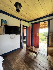 a living room with a flat screen tv on the wall at Capricho Asturiano in Santo Antônio do Leite