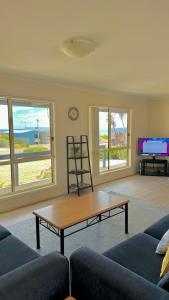 a living room with a couch and a coffee table at Catch N Relax in Point Turton