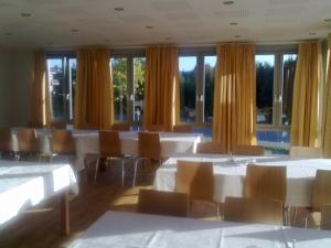 a conference room with tables and chairs and windows at Birgittaklosteret i Trondheim in Trondheim