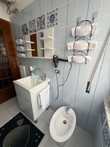 a bathroom with a toilet and a sink at Carmen House in Bernalda