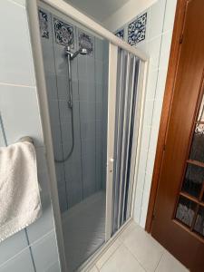 a shower with a glass door in a bathroom at Carmen House in Bernalda +1 photo