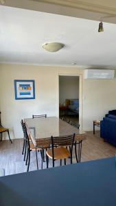 a living room with a table and chairs and a couch at Catch N Relax in Point Turton