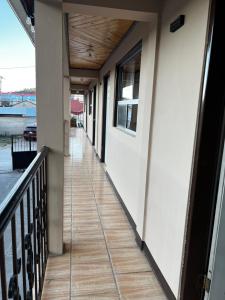 a hallway of a house with a door and a balcony at hotel Rarámuri in Creel