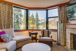 a living room with a couch and a fireplace at Everline Resort Suite: North Lake Tahoe Luxury! in Olympic Valley