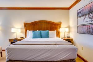 a bedroom with a large bed with blue pillows at Everline Resort Suite: North Lake Tahoe Luxury! in Olympic Valley +29 photos