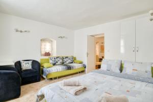a living room with a couch and a bed at Old Town Boskovic Apartment in Kotor