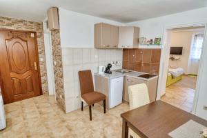 a kitchen with a table and chairs in a room at Old Town Boskovic Apartment in Kotor +22 photos