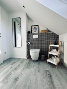 a bathroom with a large mirror and a tub at Stilvolles Apartment in Schweinfurt +13 photos
