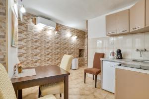 a kitchen with a table and chairs in a room at Old Town Boskovic Apartment in Kotor