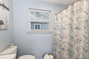 a bathroom with a toilet and a shower curtain at Gil's Bayou Cabins in Ocean Springs +44 photos