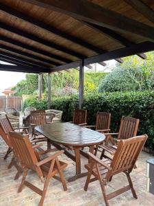 a wooden table and chairs on a patio at Villa Lara in Roseto degli Abruzzi